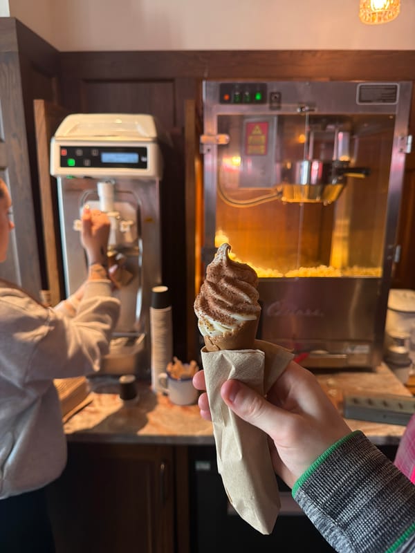 Person enjoys cocoa-dusted ice cream in London kitchen setting