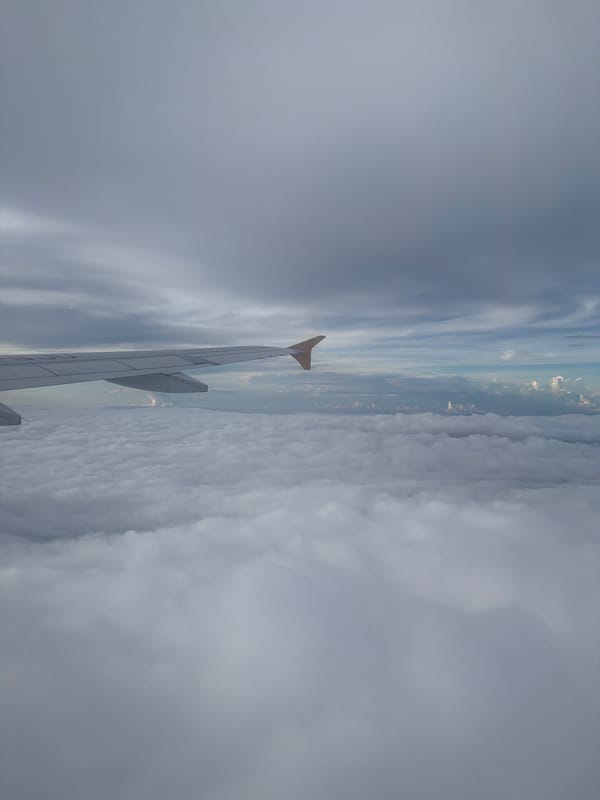 Passenger documents flight over cloudy Indonesian skies