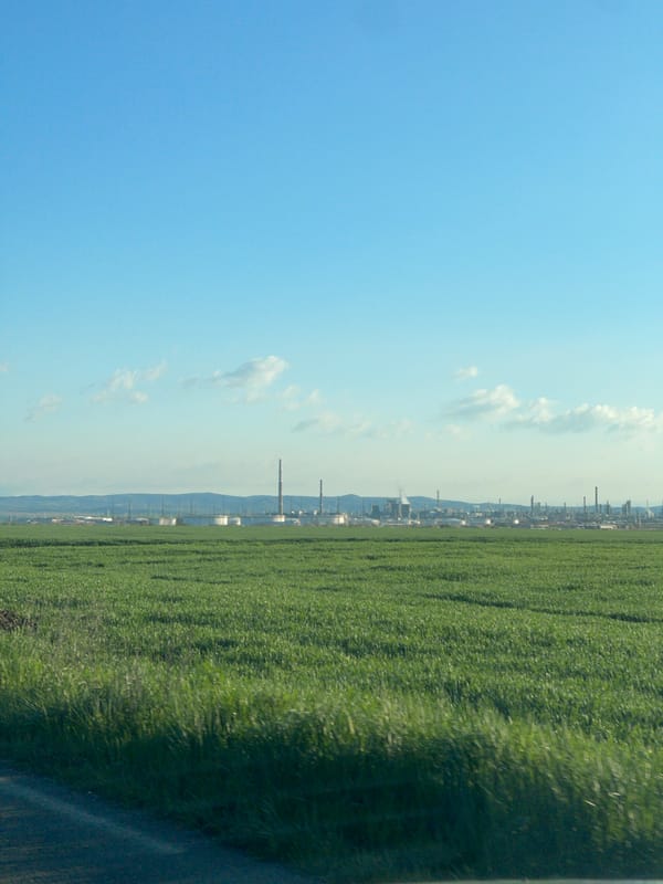 Morning view of industrial skyline from agricultural fields near Bratovo