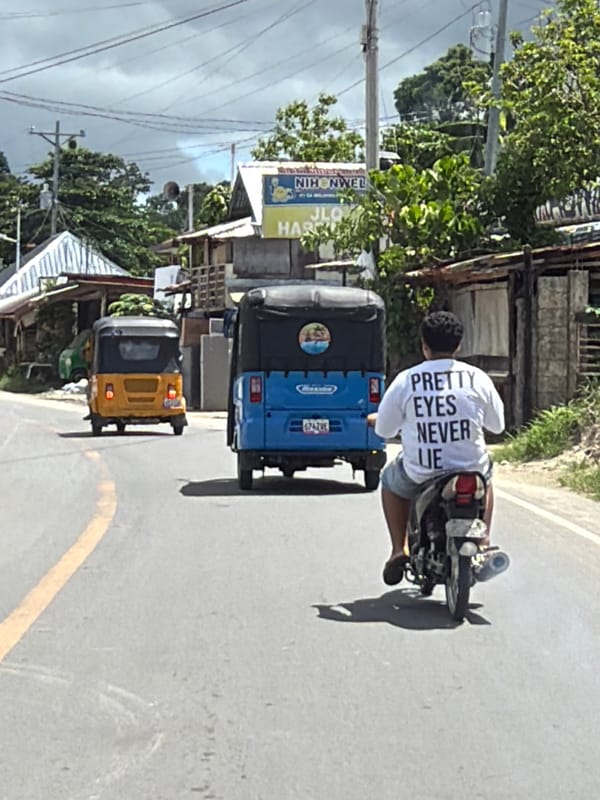 Early morning tricycle ride captured on General Luna coastal road