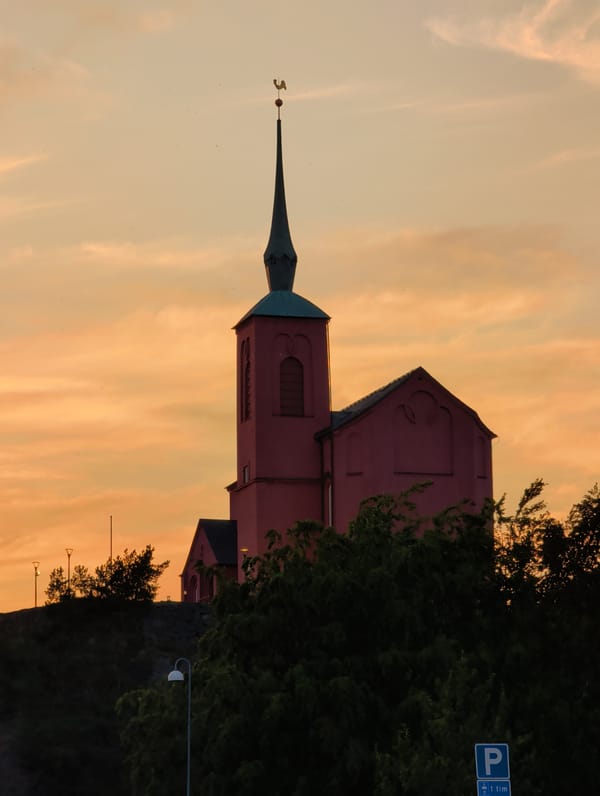 Pink church silhouetted against a warm evening sky in Nynäshamn