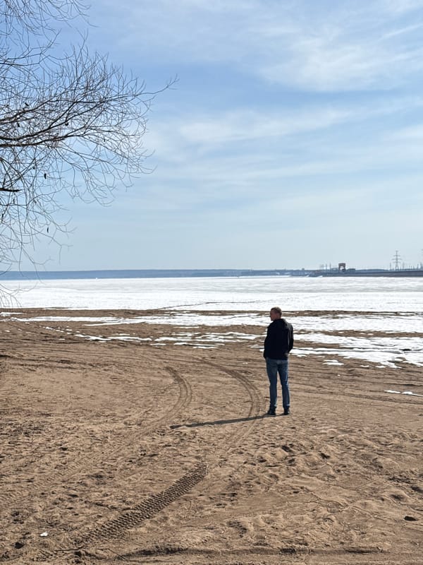 Beach visitors photographed on snowy sand in Noviy, Russia