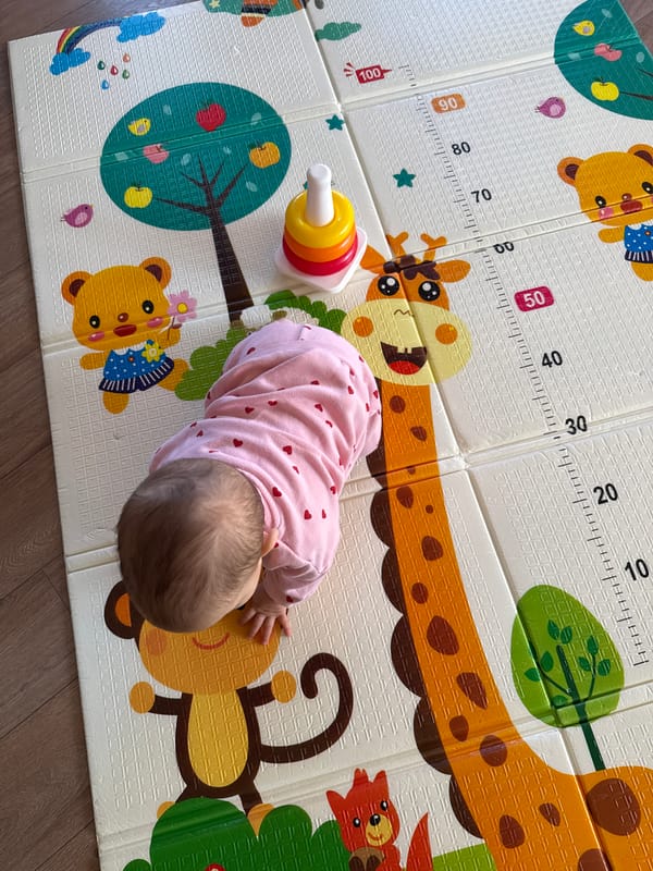 Baby plays on colorful foam mat in Sofia