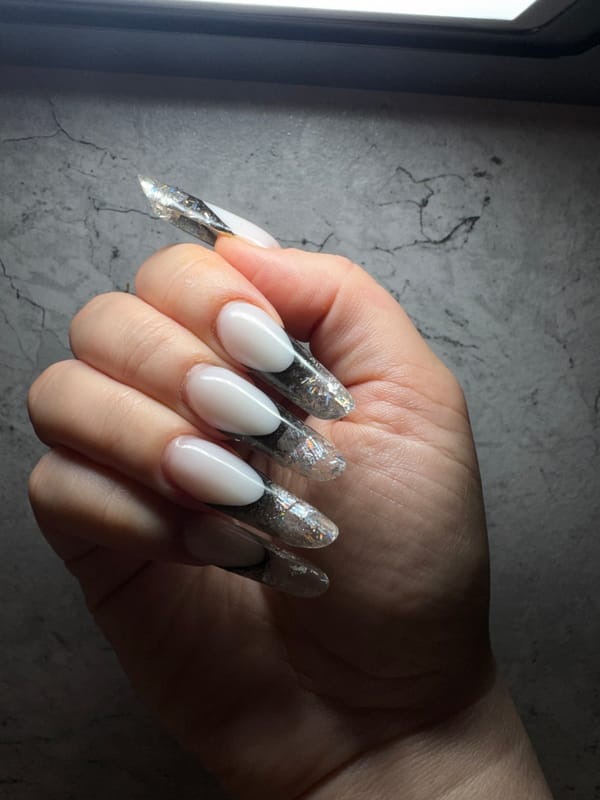 Person Shows Off White-Based Nail Art Design