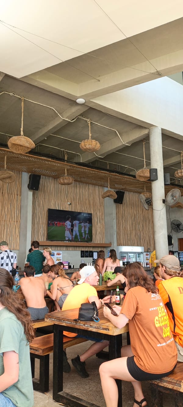 Crowd watches soccer on a big screen at Nusa Penida bar