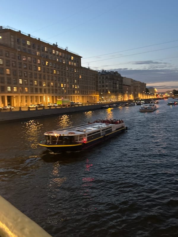 City streets and waterways at dusk, old architecture and street life