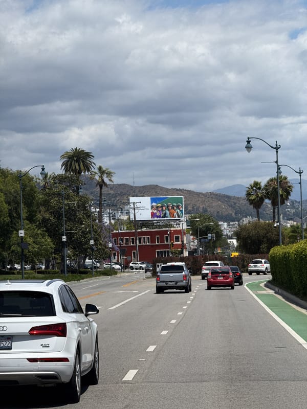 Beverly Hills street traffic documented under cloudy afternoon skies