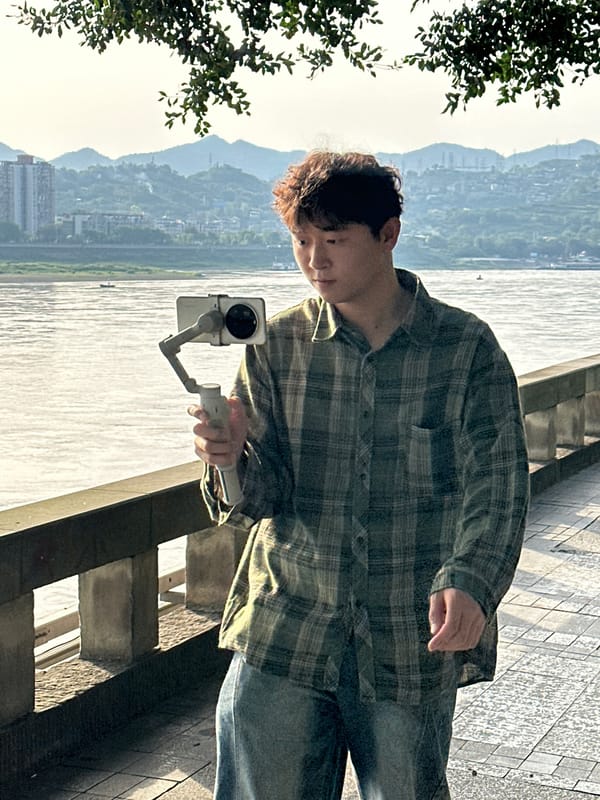 People gather with filming equipment on Jiangjin waterfront promenade