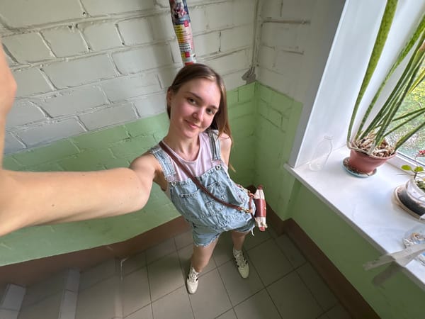 Woman takes selfie in residential building hallway in Perm