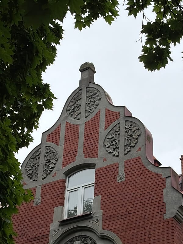 Ornate brick architecture and summer foliage in Kaliningrad