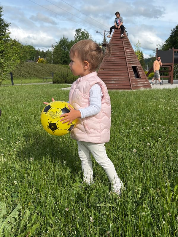 Toddler plays with soccer ball in Wisła park