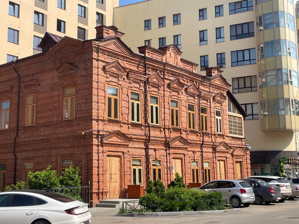 Ornate red brick building on a classic urban street