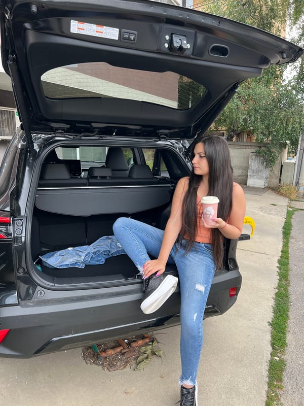 Chilling in an SUV trunk with a drink, Sofia