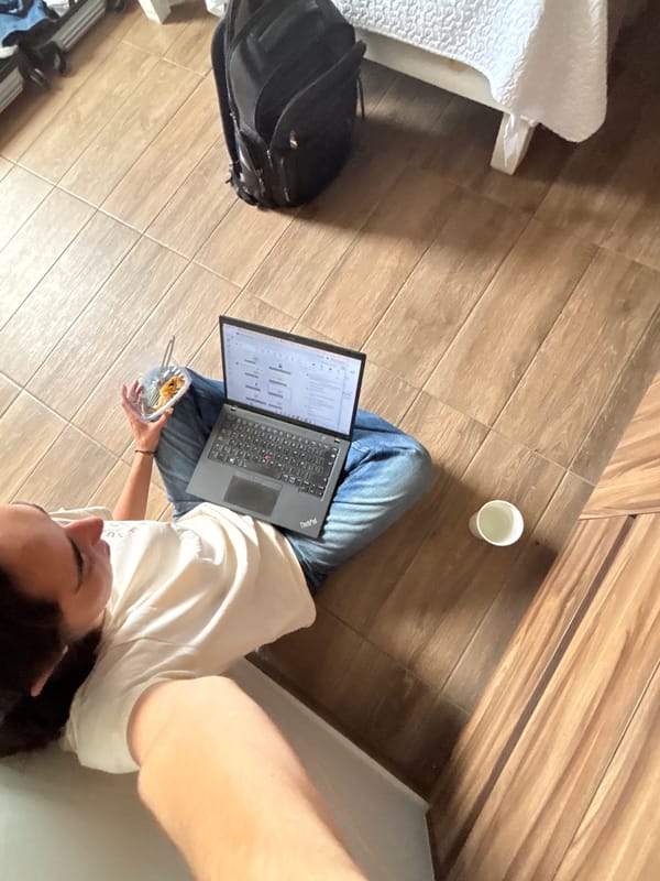 Person works on laptop from floor in Tlaxcalancingo