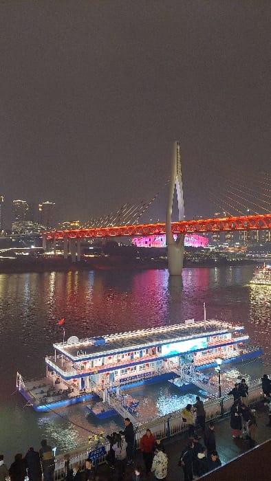 Evening crowds gather at Chongqing's illuminated Hongyadong tourist district