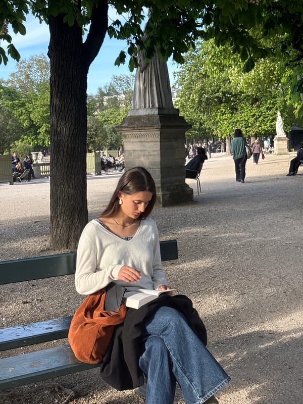 Woman sits on bench in Paris's Luxembourg Gardens