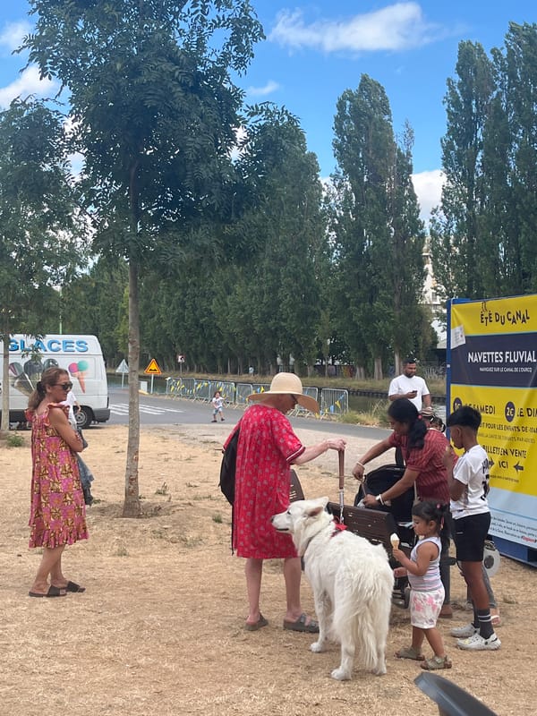Community festival in Bobigny with giant pink elephant and canal activity