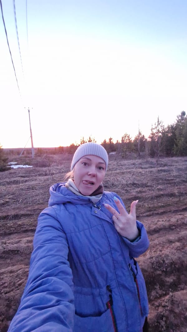 Woman poses playfully in rural Otchor countryside during golden hour