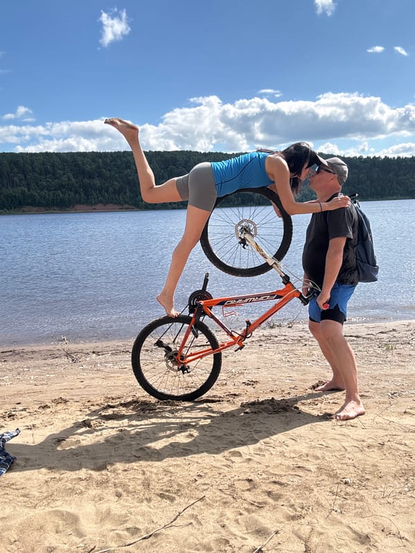 Couple enjoys beach bicycle activities in Ol'khovskoye, Russia