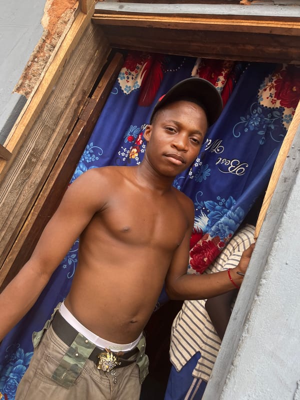 Young man photographed with Toyota vehicle in Idah, Nigeria