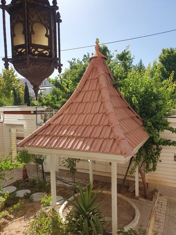 Ornate metal lantern observed in sunny garden setting