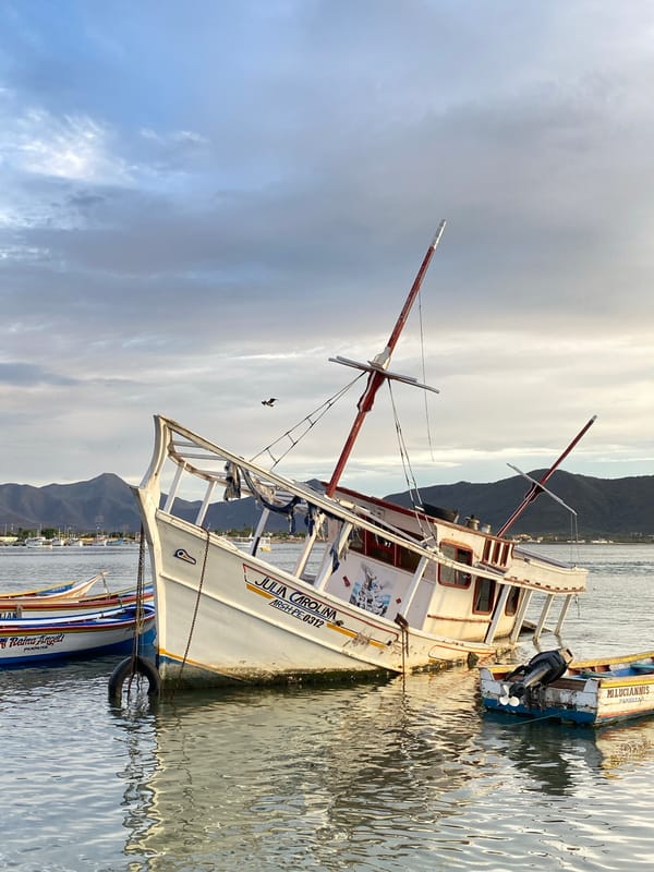 Fishing boat listing in Juan Griego harbor at dusk