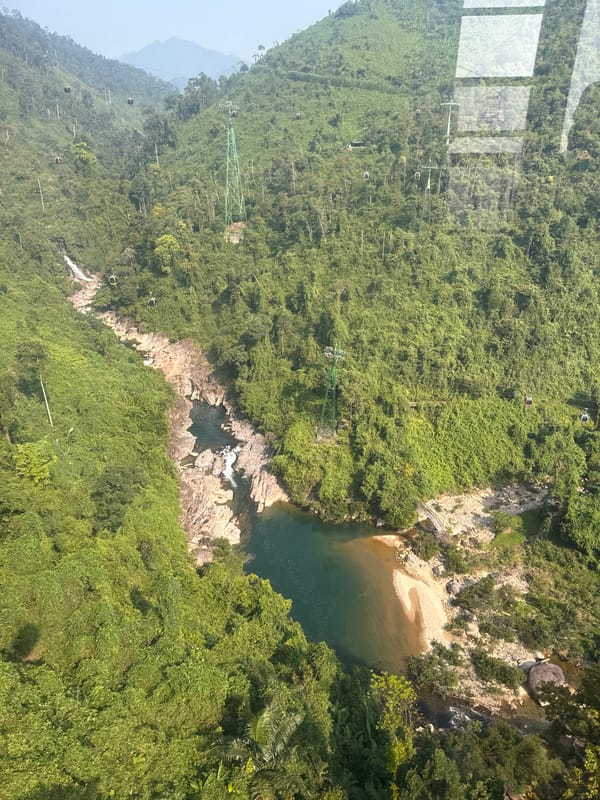 Cable car riders capture scenic mountain views in Vietnam