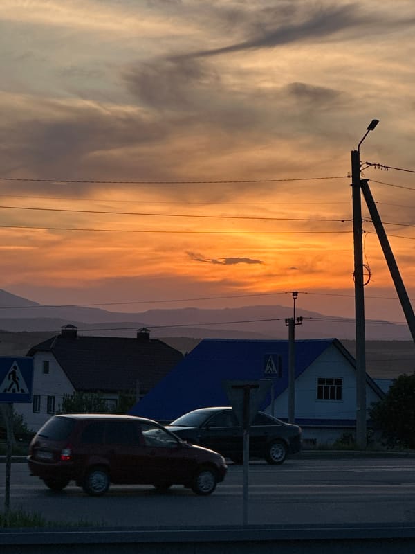 Sunset street scenes with vehicles captured across residential area