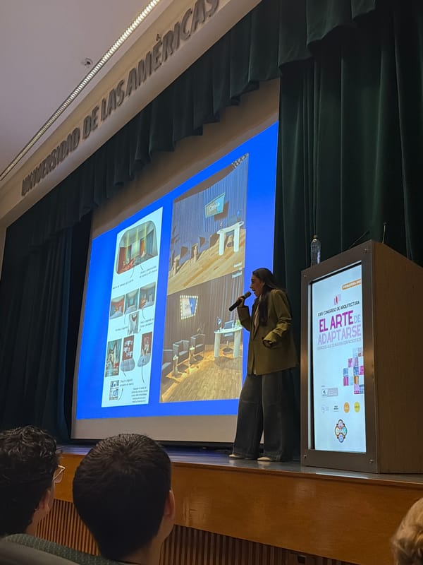 Person gives presentation at podium with microphone and screen