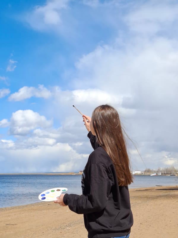 Artist paints by waterside in Chaikovsky, Russia