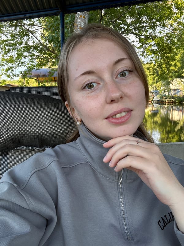 Woman photographs ducks and takes selfies at waterside dock