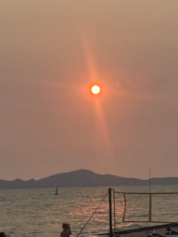 Beach volleyball game observed during sunrise in Pattaya
