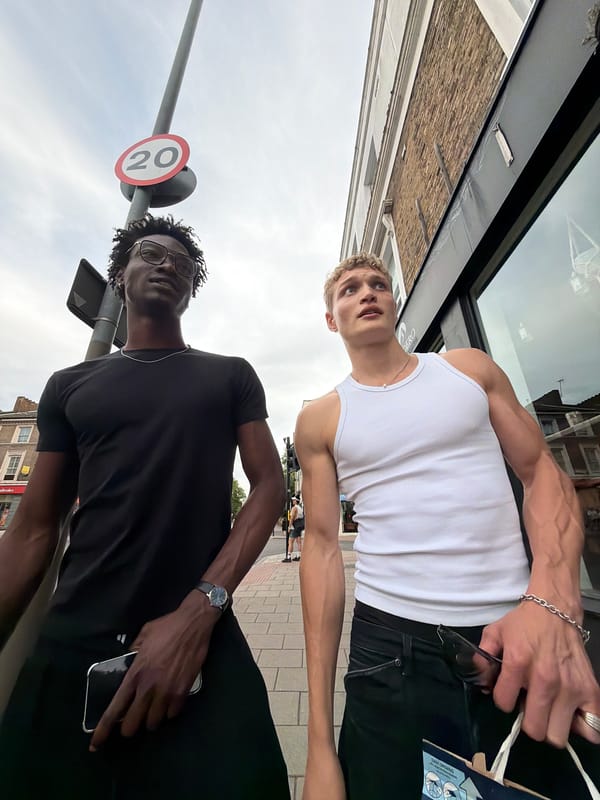 Friends pause for a selfie on a busy London street