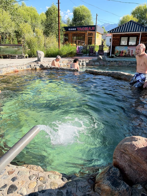 Sunny day at a turquoise outdoor hot spring resort