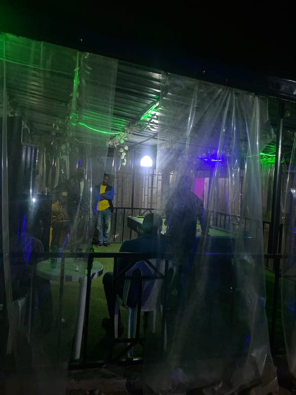 Evening pool game captured at outdoor bar in Jos