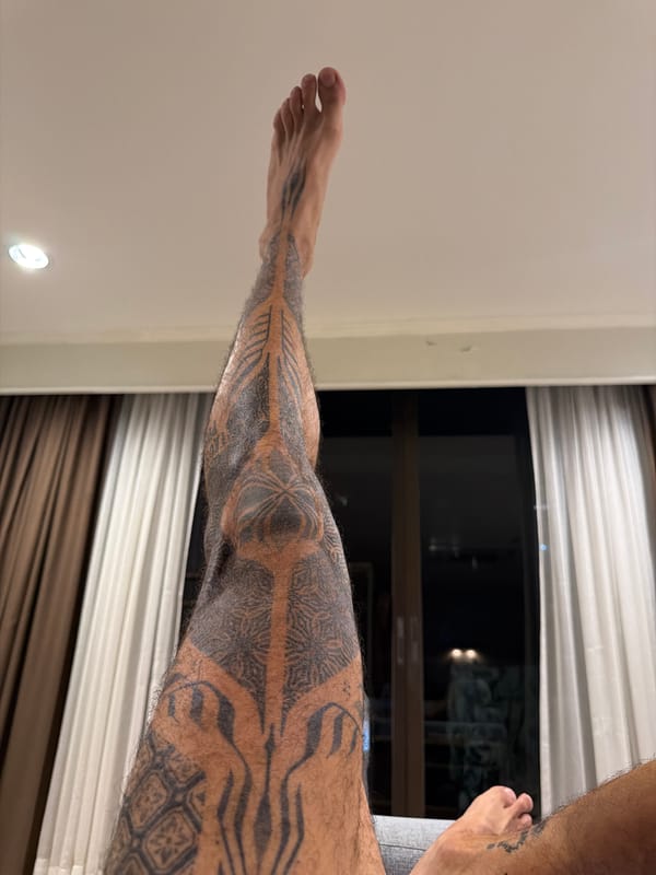 Tattooed man photographed lying on surface in Bangkok