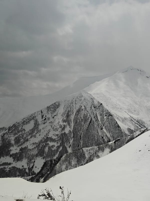 Overcast skies blanket snow-covered mountains in Gudauri, Georgia