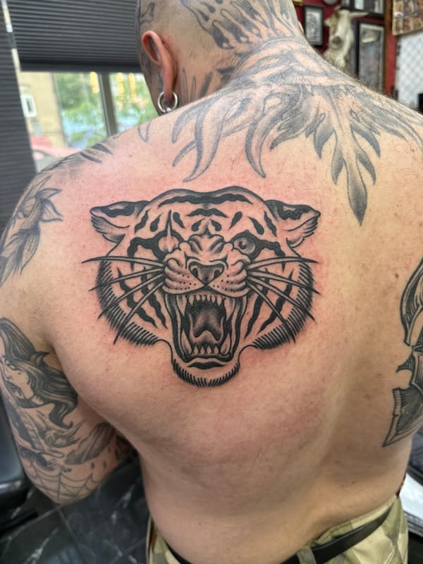 Fresh tattoo work completed in Moscow featuring tiger, sun designs