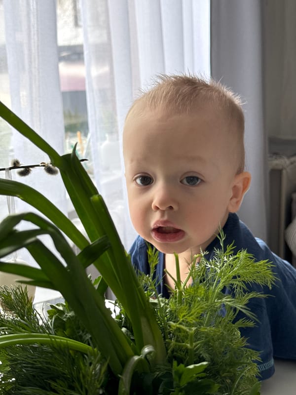 Baby photographed among green plants in Chaikovsky, Russia