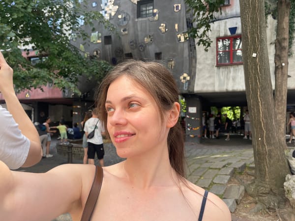 Tourist documents Vienna's colorful Hundertwasserhaus in morning photo session
