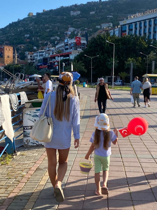 Tourist documents pirate ships and flowers during Alanya harbor walk