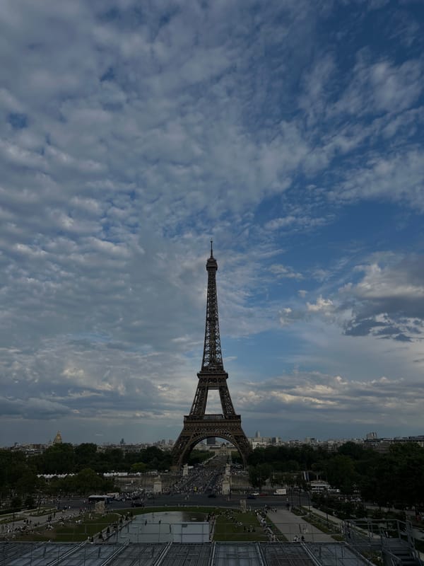 Eiffel Tower park scene on a cloudy summer afternoon