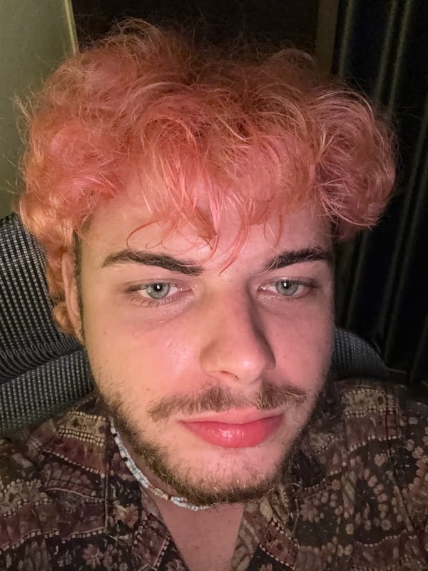 Pink-haired man documented in domestic setting, Đà Nẵng Vietnam