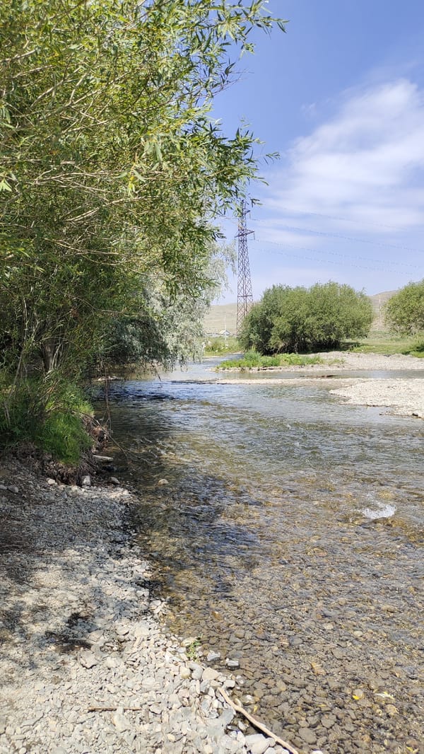 Wading in a clear rocky river outside Taldykorgan