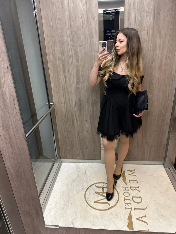 Woman photographs herself in elevator, poses for portrait in Bulgaria