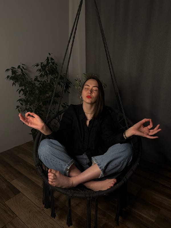 Woman relaxes in hanging chair in Chaikovsky home