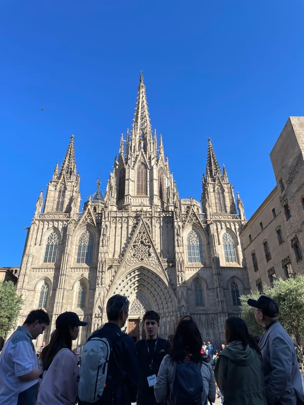 Female duo busks outside Barcelona Cathedral drawing afternoon crowds