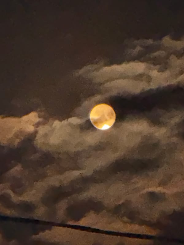 Full moon breaking through clouds over Sokhumi