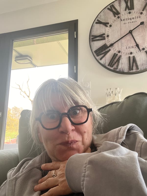 Woman takes casual selfies in French town, cat wanders nearby