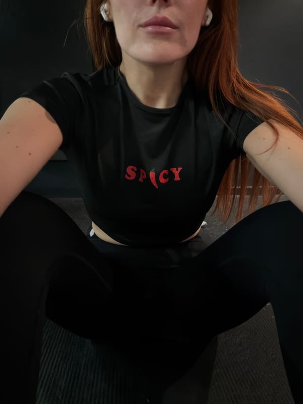Person in SPICY shirt rests on surface in Paris